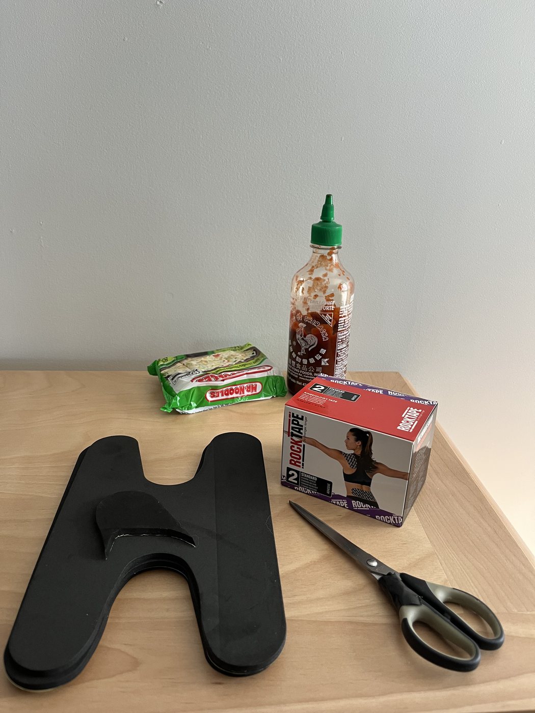 Tools for the expedition boot heel-lock modification: liner, EVA foam, tape, scissors, and optional ramen