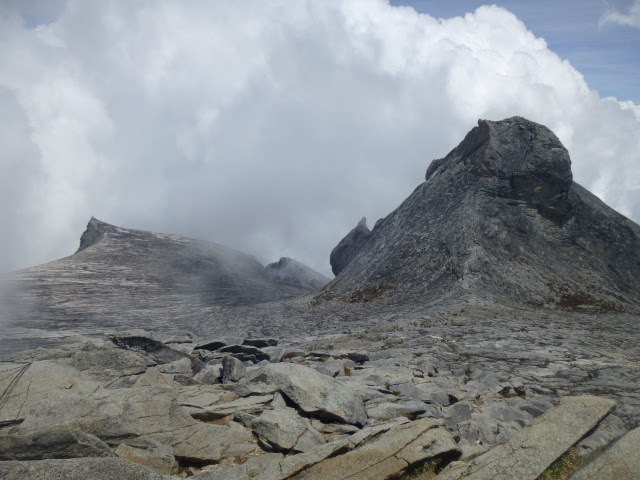 Rocky summit plateau near the top of Mount Kinabalu above the clouds.